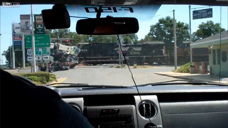 18-wheeler-carrying-crane-gets-smashed-to-pieces-by-freight-train-video-87453-7
