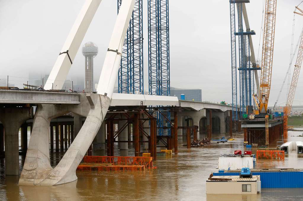 Recent rains have flooded the Trinity River bottoms near downtown Dallas and slowed work on the Margaret McDermott Bridge (Tom Fox, Dallas Morning News)