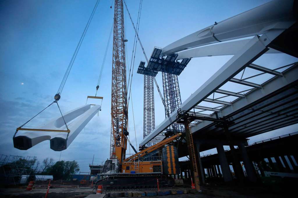 The connected arch segments comprising the 'dog leg' segments, EA4 north, EA4 south, EA5 north and EA4 south, are lifted into place on the new signature Margaret McDermott Bridge alongside eastbound Interstate 30 near downtown Dallas, early Wednesday, April 8, 2015. The new Santiago Calatrava designed bridge will give pedestrian and bicycle access in and out of downtown Dallas, the floodway and Oak Cliff. (Tom Fox, Dallas Morning News)