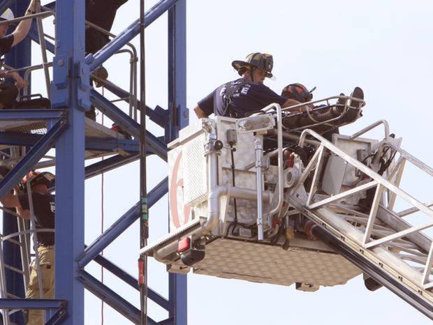 Oklahoma City Fire Dept. crews perform CPR on a crane operator as he is removed by ladder truck from the crane at 800 Stanton L. Young Blvd. in Oklahoma City, OK, Monday, July 20, 2015, Photo by Paul Hellstern. The Oklahoman