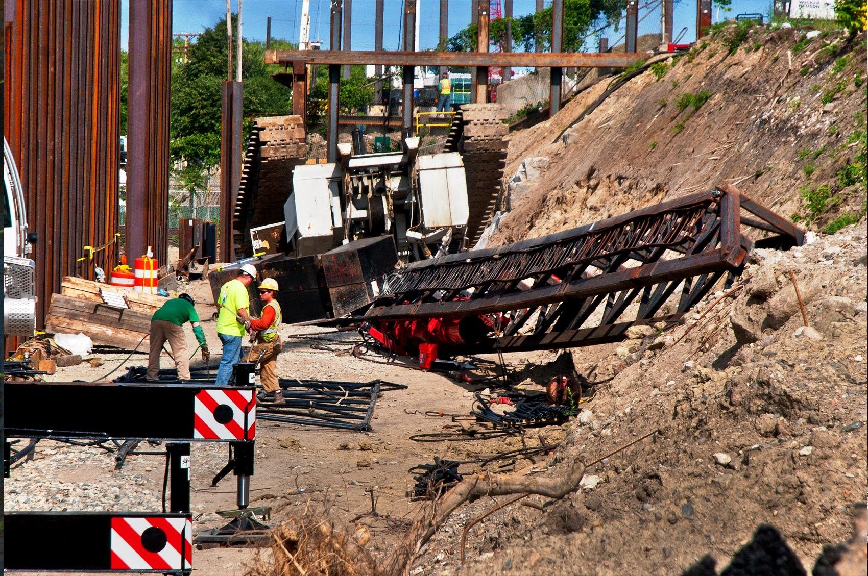 Workers continue cleaning up around a crane that toppled over on July 7 on Brainard Avenue. Photo by Greg Mirochuk