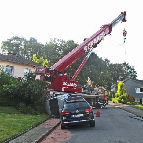 The crane ran backwards down the hill into the cars